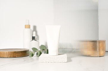 Blank white tube mockup for cosmetics product presentation on a bathroom table.