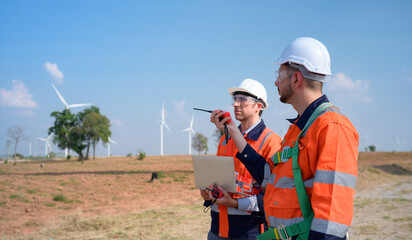 Surveyor and engineer Examine the efficiency of gigantic wind turbines that transform wind energy...