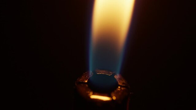 macro shot of a flame igniting out of a lighter, fire on a black background
