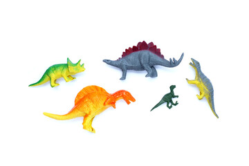 Plastic dinosaur toys on white background. Top view