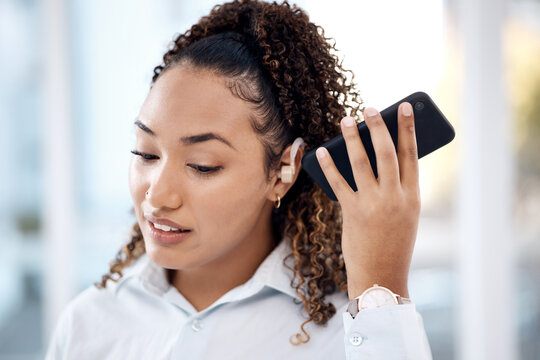 Black woman, phone call and loudspeaker to listen in office with hearing aid for corporate communication. Young executive, smartphone accessibility and disability in workplace with networking