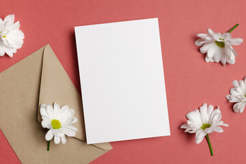 Blank paper greeting card mockup with envelope and white flowers