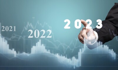 Young smart business man worker with 2023 graph