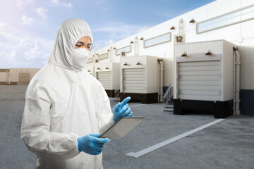 Asian worker or engineer wear protective coverall suit work at warehouse