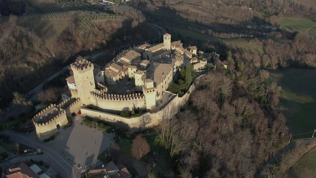 drone aeria sunsetl view of Vigoleno Castle , fortress village and hills, scenic panorama in Parma, Emilia Romagna , Italy.
