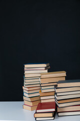 stack of books on a dark background in the library at the educational institution