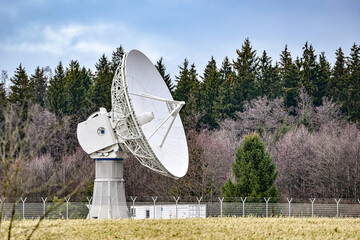 Satellite radio and TV antennas in the forest.