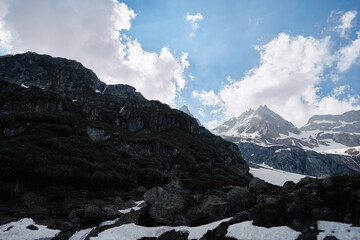 Fototapeta na wymiar Travel by Switzerland. Beautiful Alpine mountains landscape with snowy hiils.