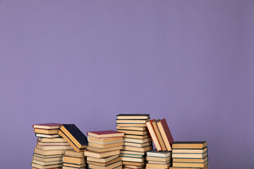 many books stacks on a purple background in the library science college university training