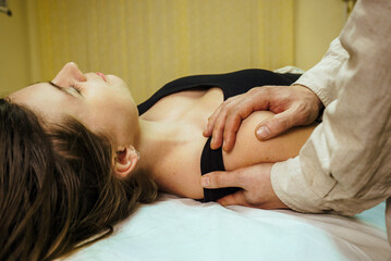 male osteopath conducts a CST treatment session for a woman 5