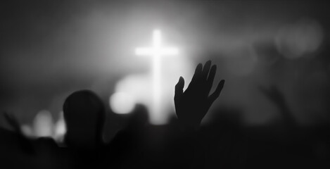 Passionate Christian praising with hands raised towards the cross and Holy Spirit filled gracious church worship with bokeh and silhouette background
 - obrazy, fototapety, plakaty