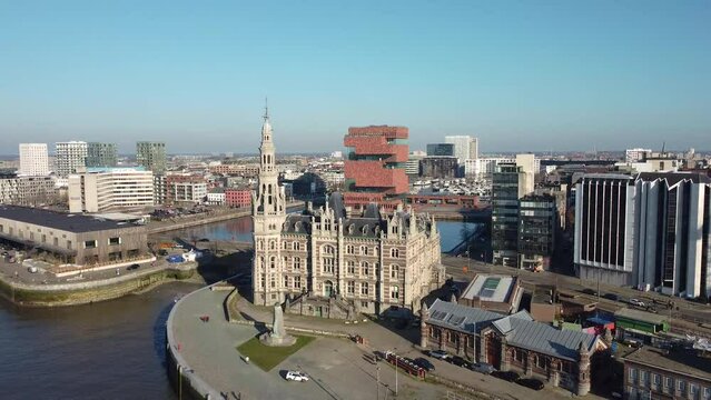 Drone aerial view over the loodsgebouw (the Antwerp pilot building) in the Belgian city of Antwerpen and the MAS museum in the backgound.