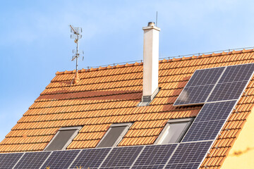 solar panels for the production of electricity from the sun on the roof of a family house