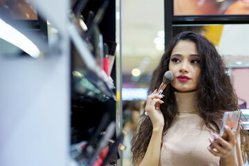 A girl in a cosmetics store. Fashion and beauty industry
