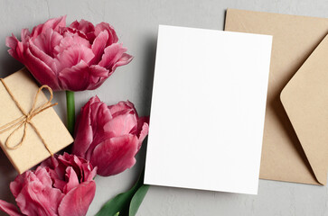 Blank greeting card mockup with envelope, gift box and pink peony flowers, valentines day greeting card mockup