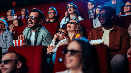 Audience laughing in 3D cinema. - obrazy, fototapety, plakaty