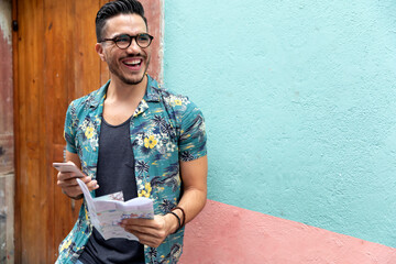 Mexican man traveling in Guanajuato. Student exploring a colorful city. 