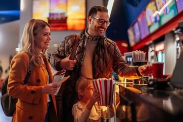 Cheerful family in movie theater.