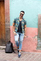 Mexican man traveling in Guanajuato. Student exploring a colorful city. 
