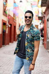 Mexican man traveling in Guanajuato. Student exploring a colorful city. 