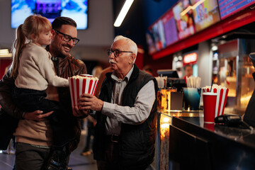 Father, son and granddaughter at movies.