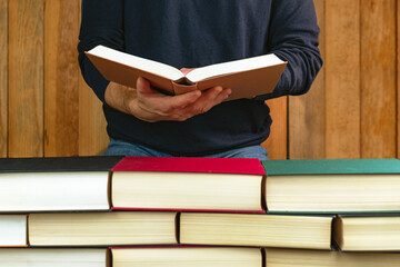 man holding and reading a book