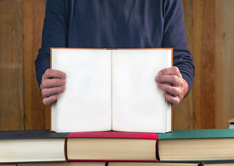 man holding a book showing its blank pages