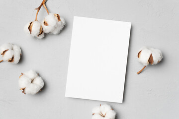 Blank invitation card mockup with cotton flowers