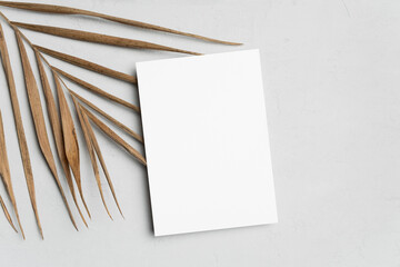 Greeting or invitation card mockup with natural palm leaf