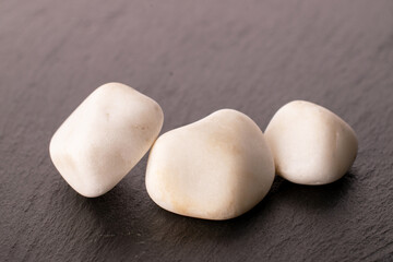 Three decorative stones for the garden on slate stone, macro.