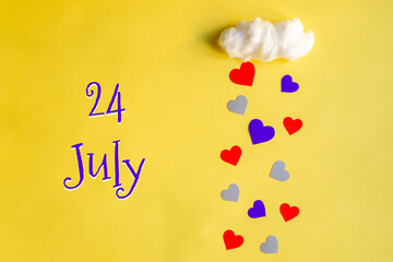 24 july day of month, colorful hearts rain from a white cotton cloud on a yellow background. Valentine's day, love and wedding concept