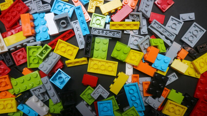 Fototapeta premium Plastic toy block on a black background