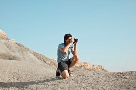 lonely man in the desert takes a photograph