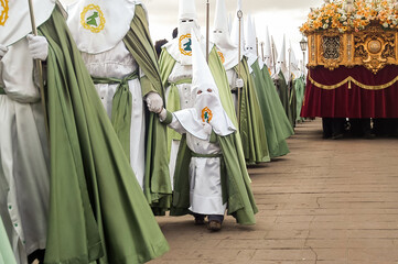 Holy Week in Zamora, Spain. Little penitent holding hands with another penitent in the procession...