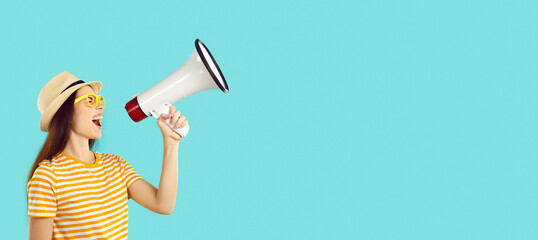Woman in holiday hat and T shirt standing on blank text space banner background, holding megaphone, promoting summer clothing store, advertising airplane ticket sale and promising fun travel overseas