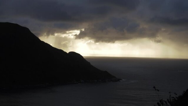 Sunset with rain clouds over Hoddevik in Norway, handheld dramatic view