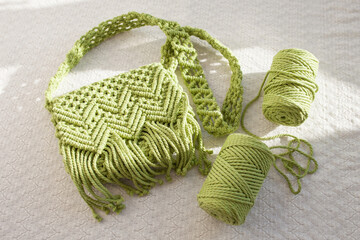 Handmade macrame cotton сross-body bag. Eco bag for women from cotton rope. Scandinavian style bag.  Light green color, sustainable fashion accessories. Details. - obrazy, fototapety, plakaty