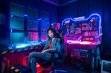 an asian woman programmer is working in her computer room , futuristic technology concept