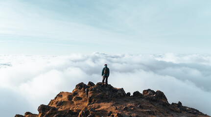 Person on top of a Mountain above the clouds. Snowdon, Wales, UK. Hiking and tourism. 