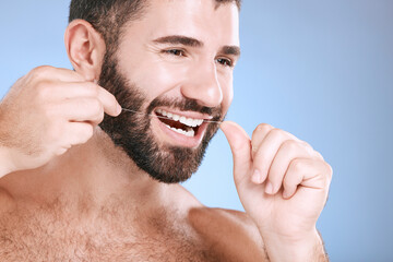 Dental, product or floss with a man in studio on a blue background with teeth hygiene for healthy...