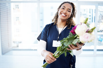 Pride, celebration and portrait of a doctor with flowers at a hospital for promotion and gift for work. Medic, happy and female nurse with bouquet as present for commitment in healthcare nursing job