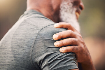 Shoulder pain, injury and hand of senior black man after fitness accident outdoors. Sports,...
