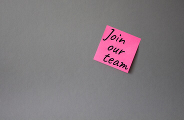 Join our team symbol. Concept words Join our team on pink steaky note. Beautiful grey background. Business and Join our team concept. Copy space.