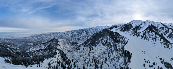 Panoramic view of the winter snowy peaks of the mountains. Panorama of the mountains
