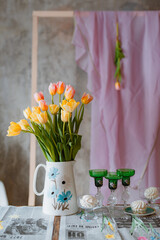 jug with tulips and wine glasses, a romantic meeting, a date, a spring holiday on March 8 and Valentine's day, a party, a newspaper tablecloth