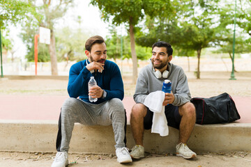 Cheerful friends taking a break from a workout