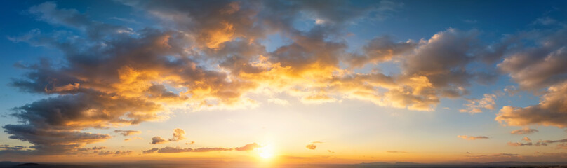 A wide panorama of a beautiful sunset sky as background or texture