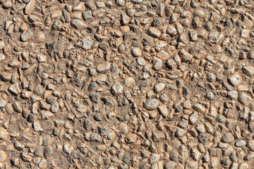 Beautiful texture of an old wall from orange stones with cracks