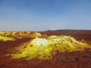 Surreal red and yellow mineral formation at Danakil Depression with strong colours in Ethiopia,...