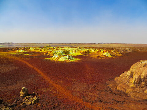 Surreal red and yellow mineral formation at Danakil Depression with strong colours in Ethiopia, Africa; looking like planet Mars - Powered by Adobe